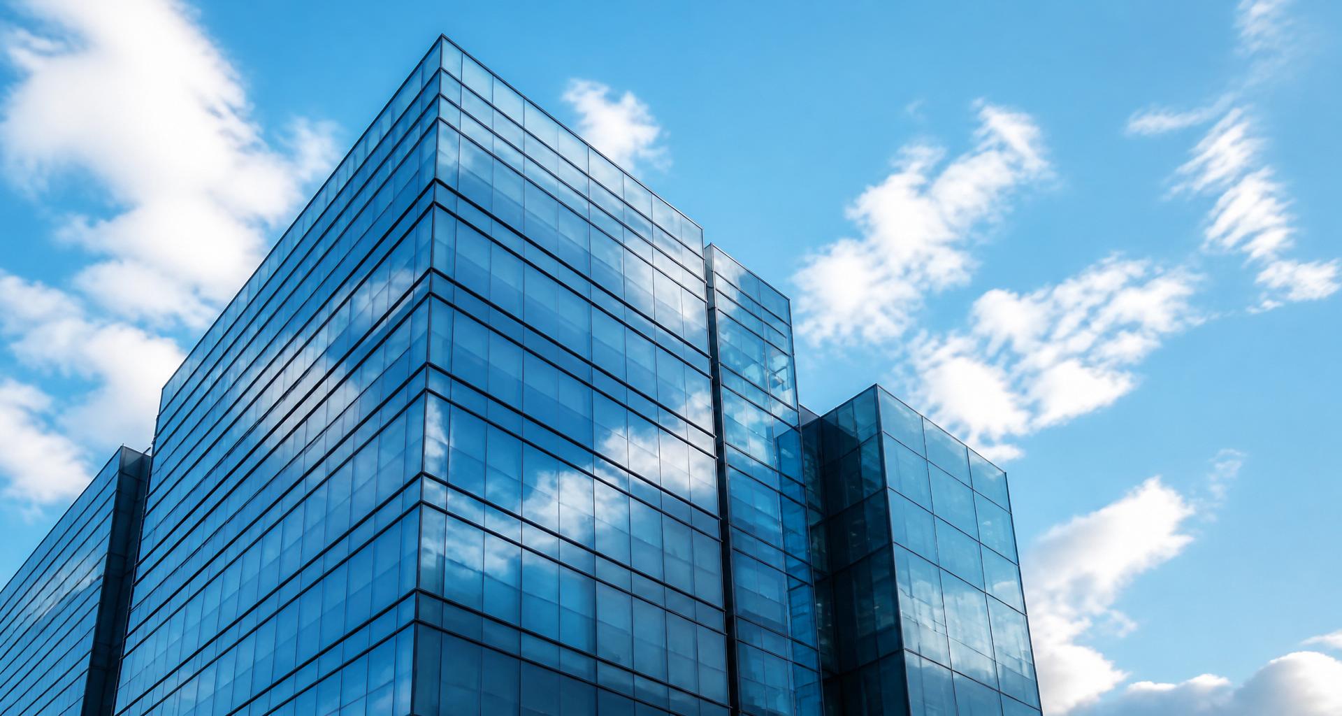 Modern corporate office building against a blue sky